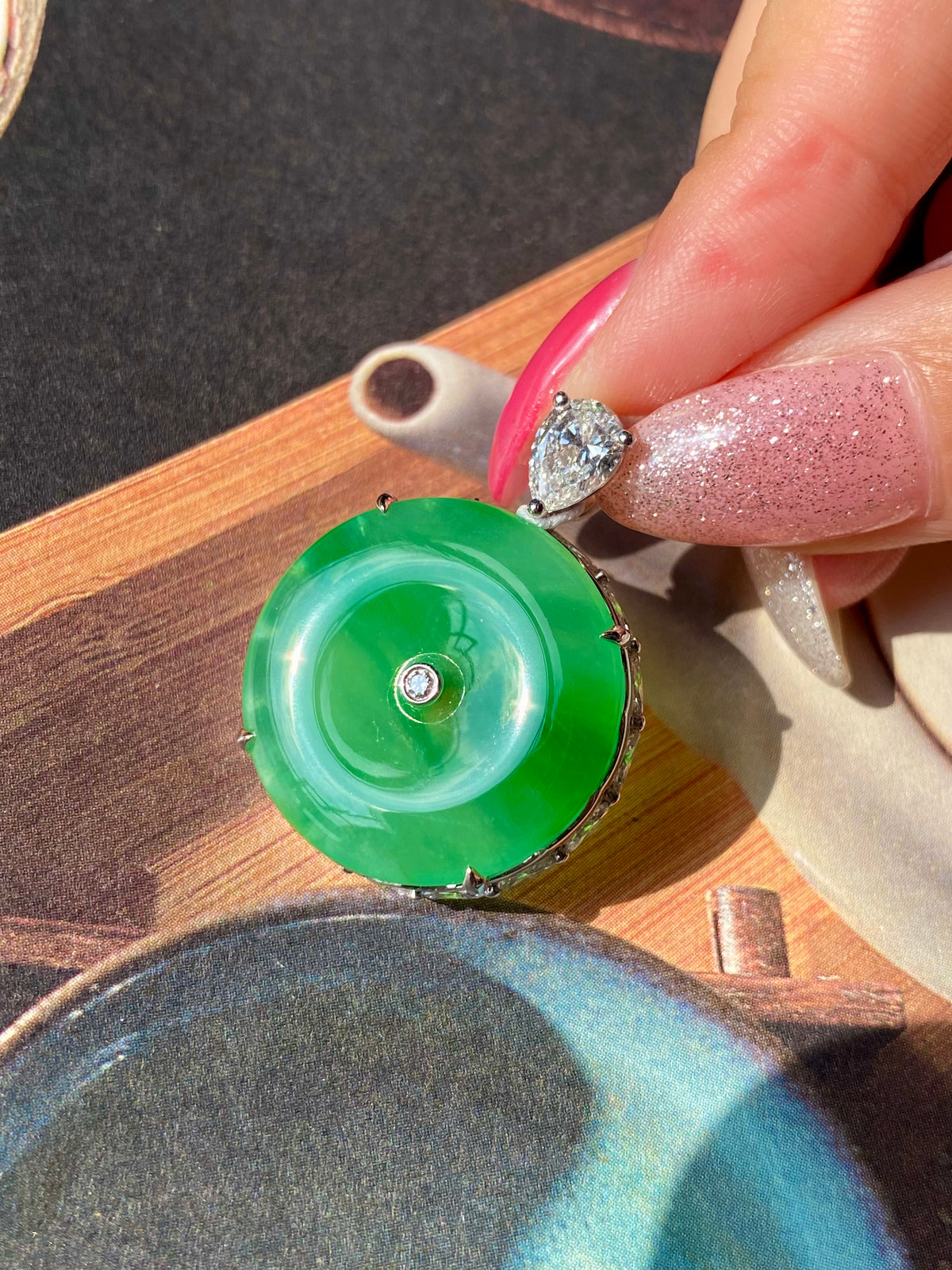 Green jadeite donut pendant with silver bail and sparkling round top stone