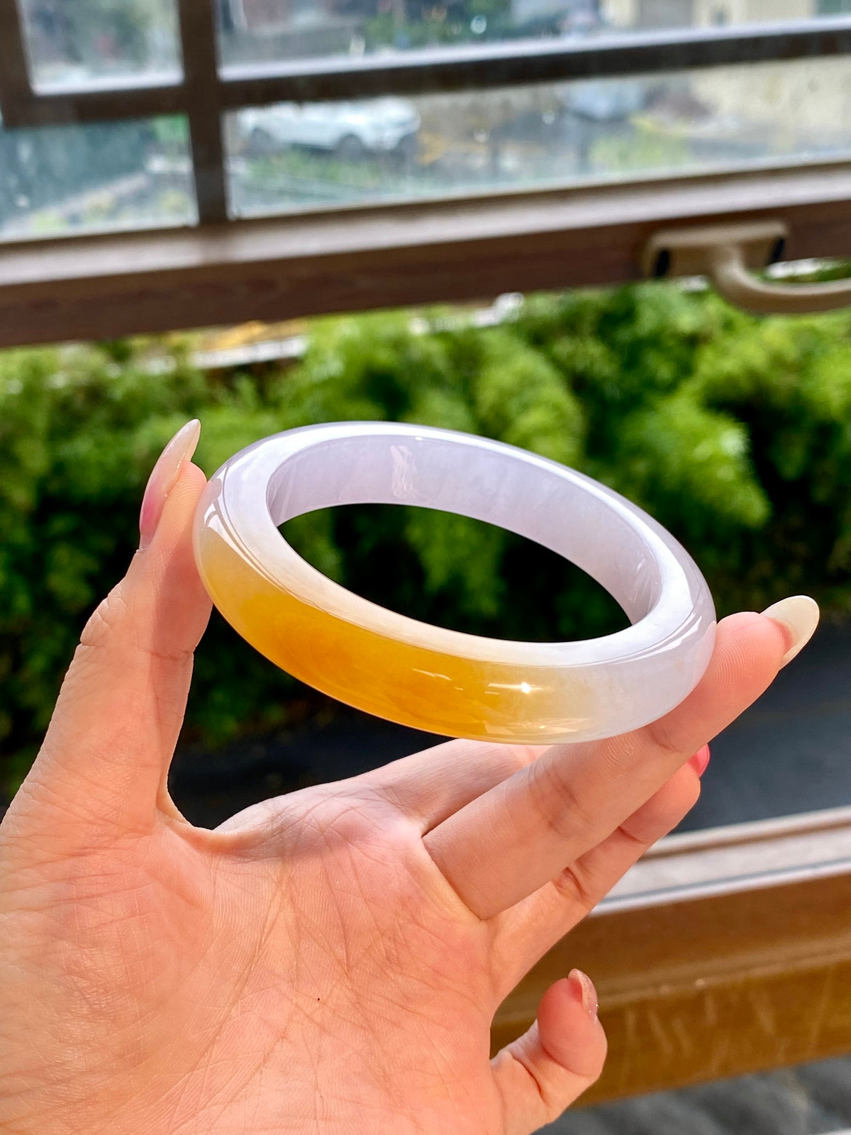 Golden-yellow jadeite bangle with pale white rim, glossy smooth circle bracelet