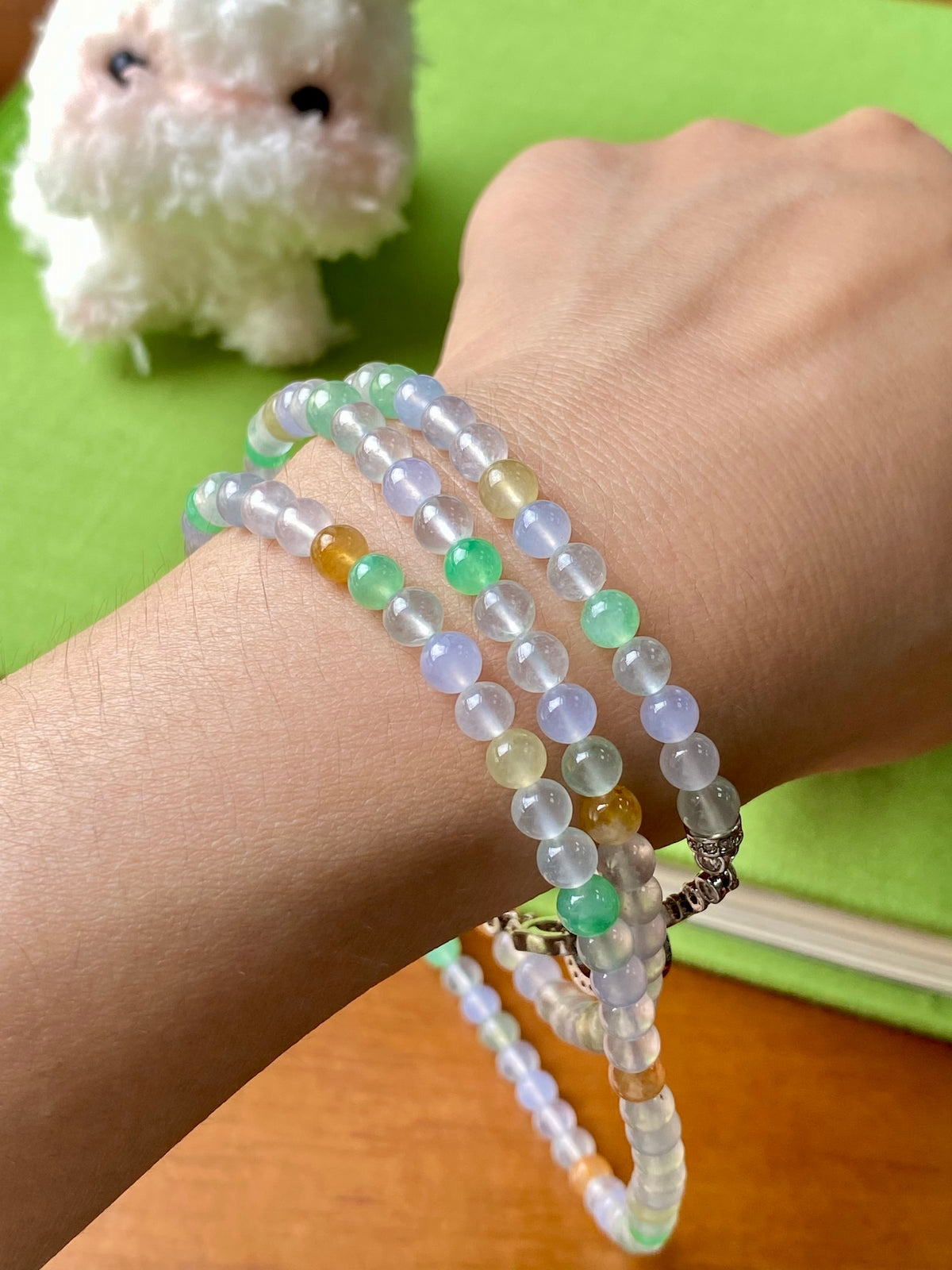 Multi-strand beaded necklace with pastel blue, green, yellow beads and metal toggle clasp