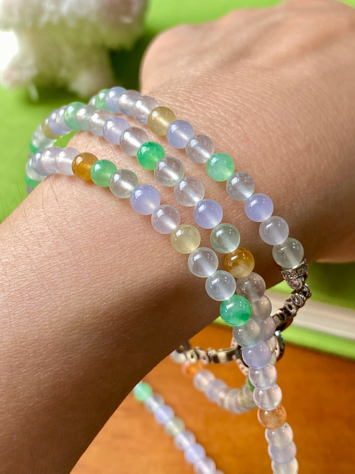 Multi-strand beaded necklace with light blue, green, yellow, orange beads and silver clasp