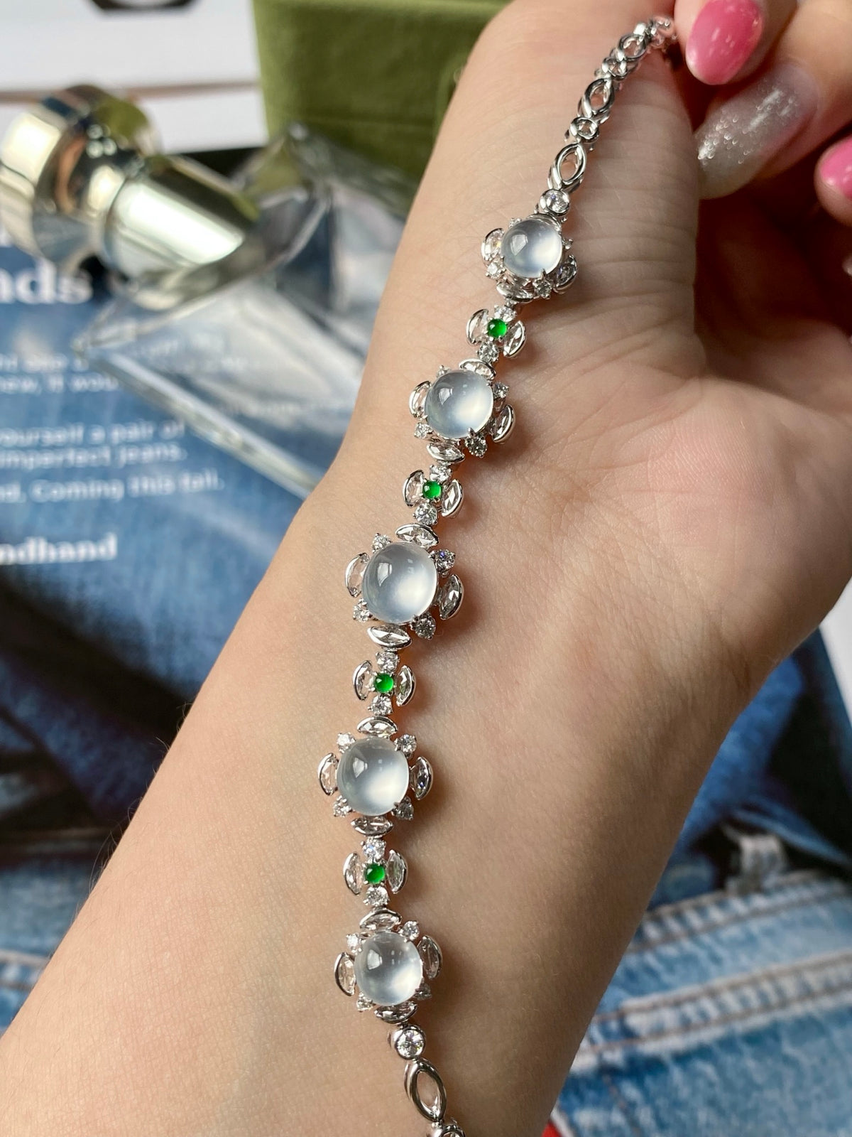 Silver-tone cabochon bracelet with icy white oval stones and small green gem accents