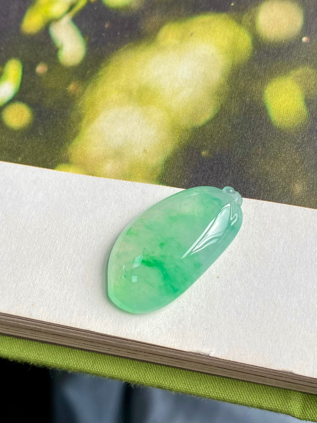 Translucent light green jadeite melon pendant, oval teardrop with small loop bail