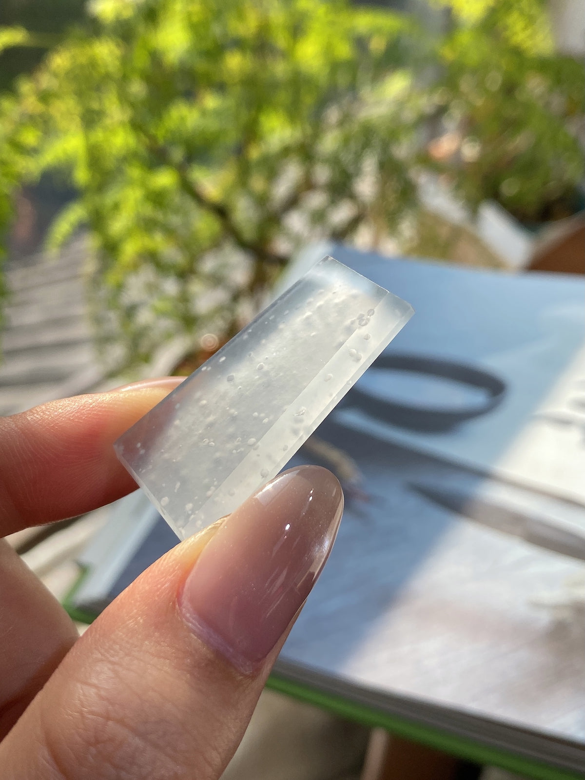 Jadeite rough stone tablet, pale translucent face with tiny speckles