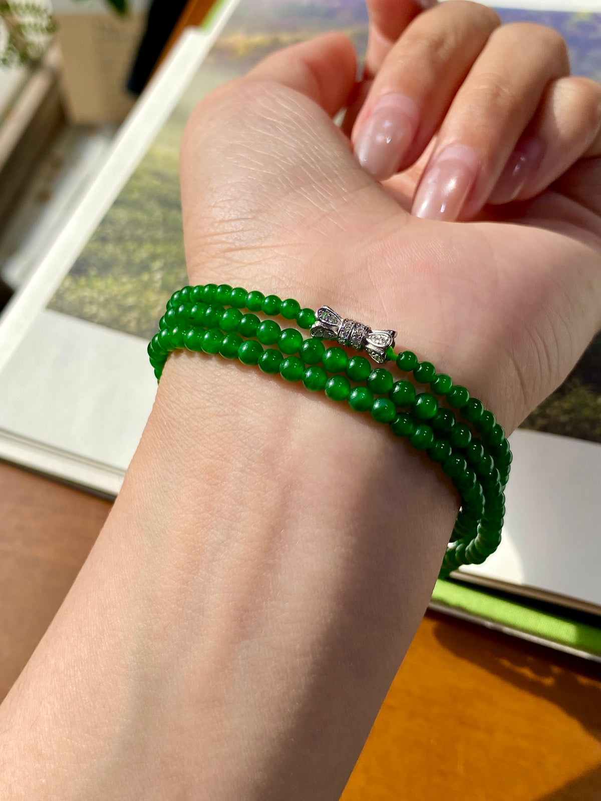 Green jadeite beaded necklace with silver clasp and small clear stone detail