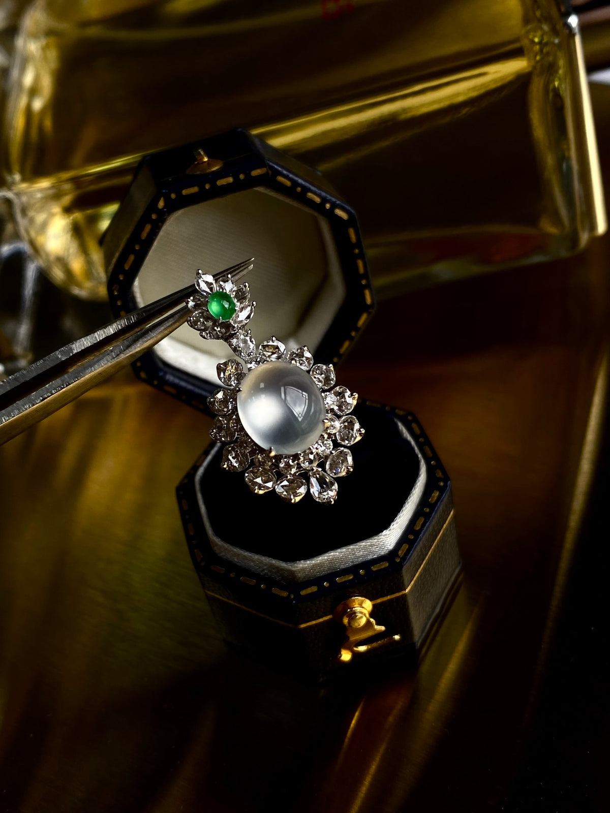 Silver-tone cabochon pendant with green accent and large round white stone in rhinestone halo