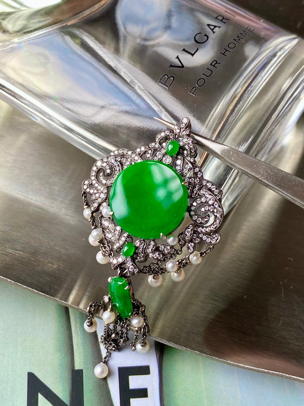 Round green jadeite brooch with silver filigree frame and dangling pearl drops