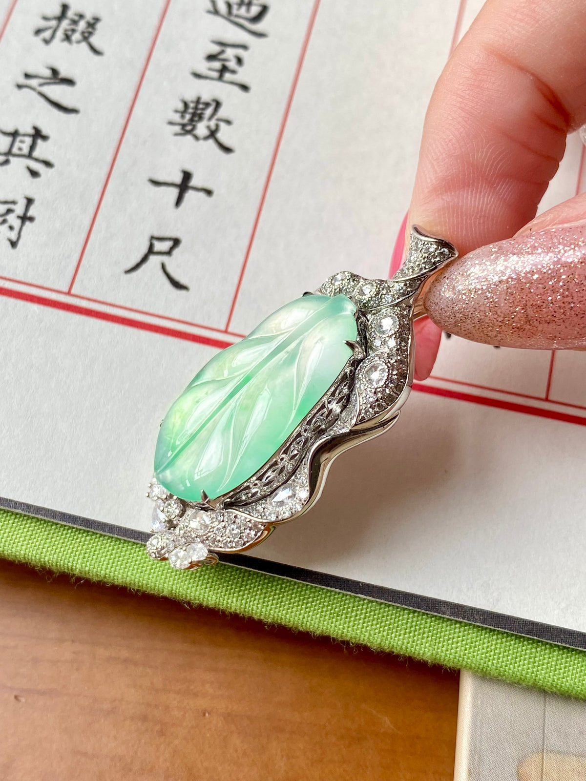 Icy green leaf-shaped pendant with marquise halo and glittering clear stones