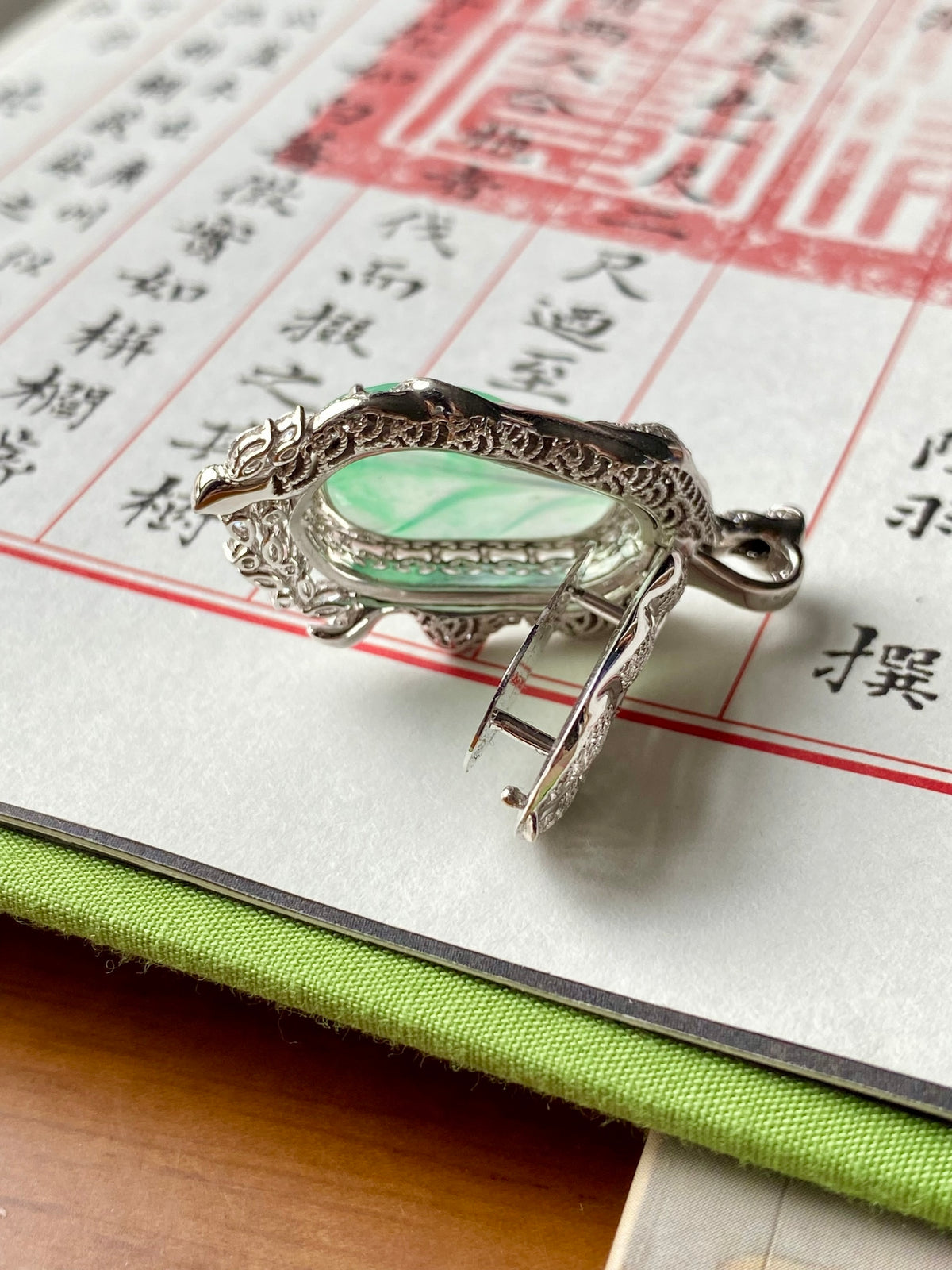 Leaf pendant clasp and back details in silver-tone with green oval inset