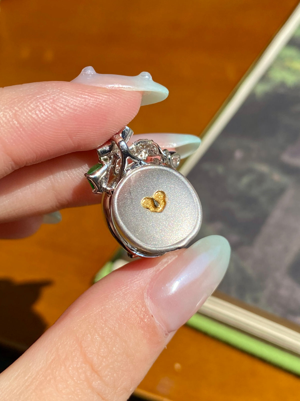 Jadeite leaf pendant back in silver with small clear stones and gold heart detail