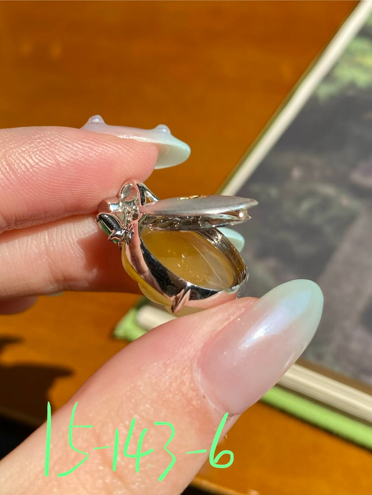 Jadeite leaf pendant with yellow translucent drop, silver prong setting, clear stones