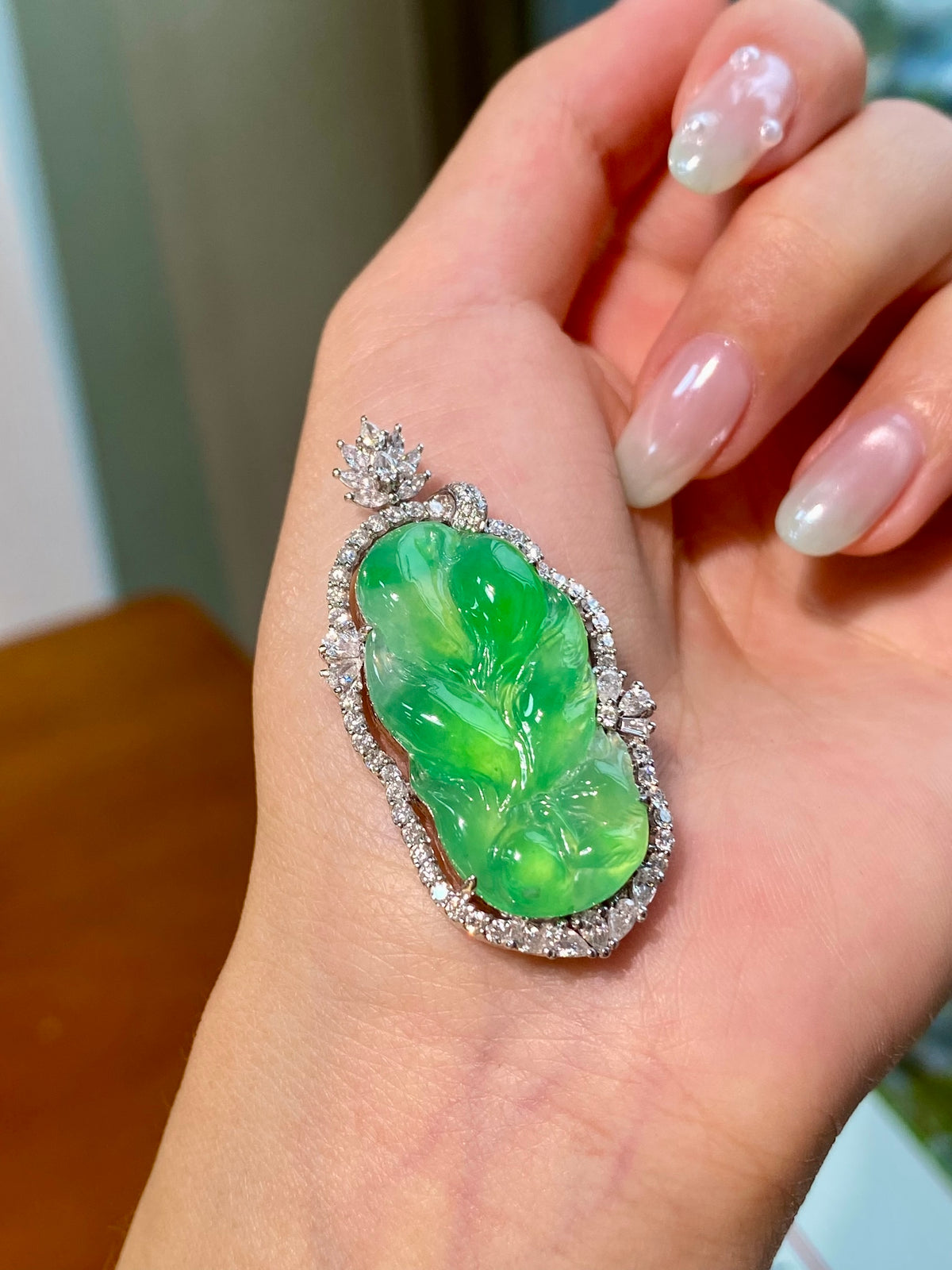 Green jadeite leaf pendant with diamond-like halo and floral top