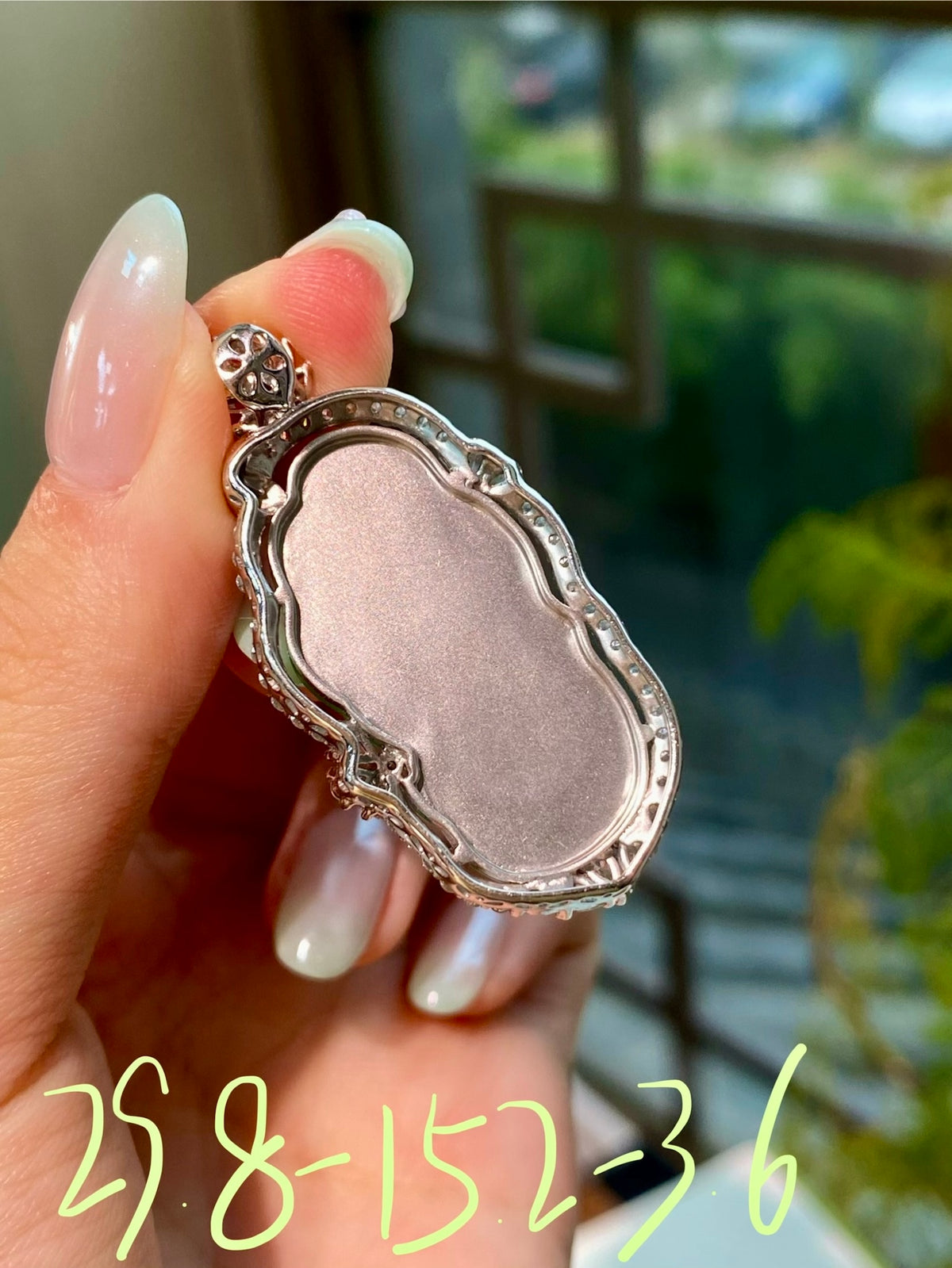 Jadeite leaf pendant, silver-tone oval setting with bail clasp
