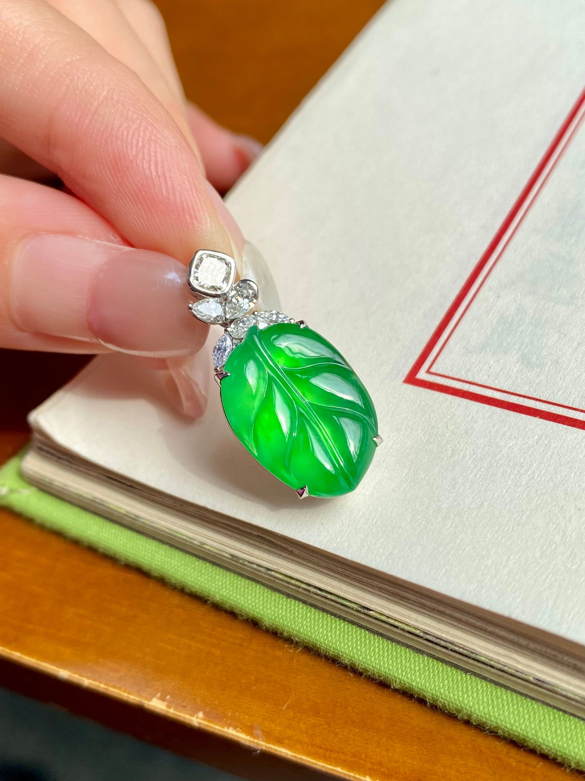 Bright green carved leaf jade pendant with silver top and dangling clear stone cluster