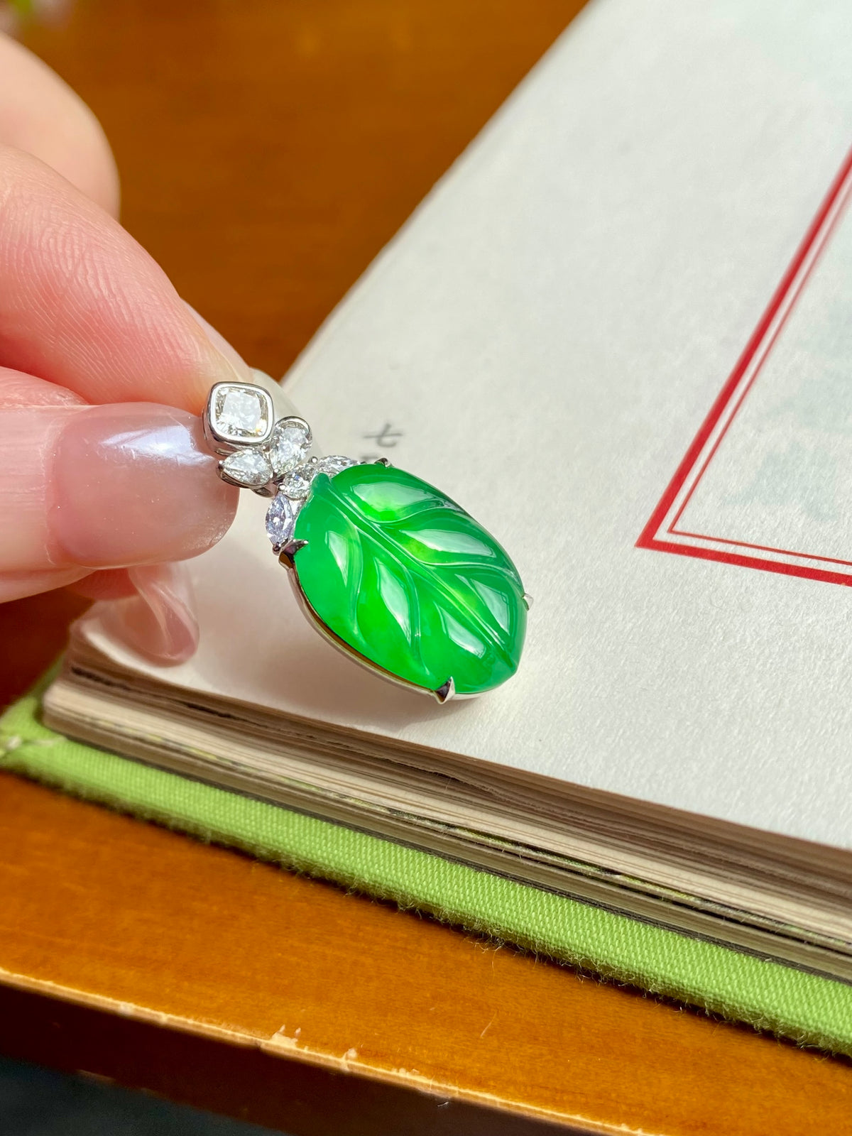 Jade leaf pendant in bright green with silver frame and small clear square stones
