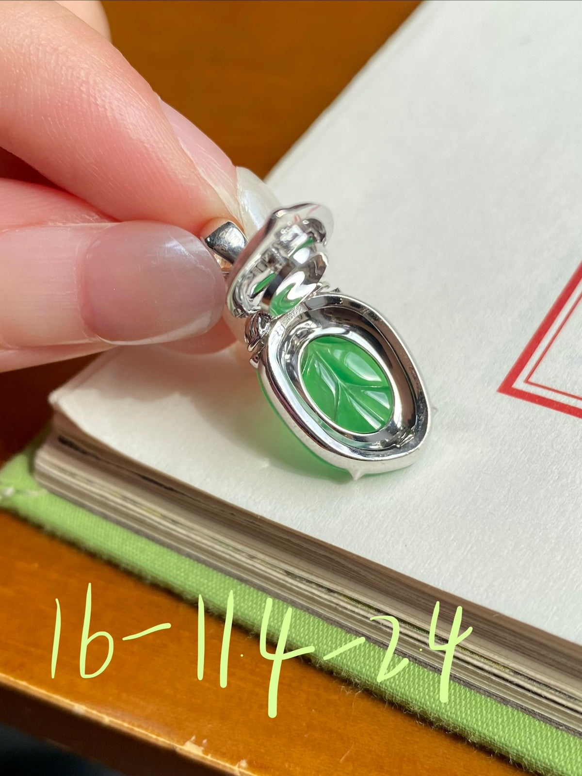 Silver jade leaf pendant with bright green carved leaf and small clear stone accents