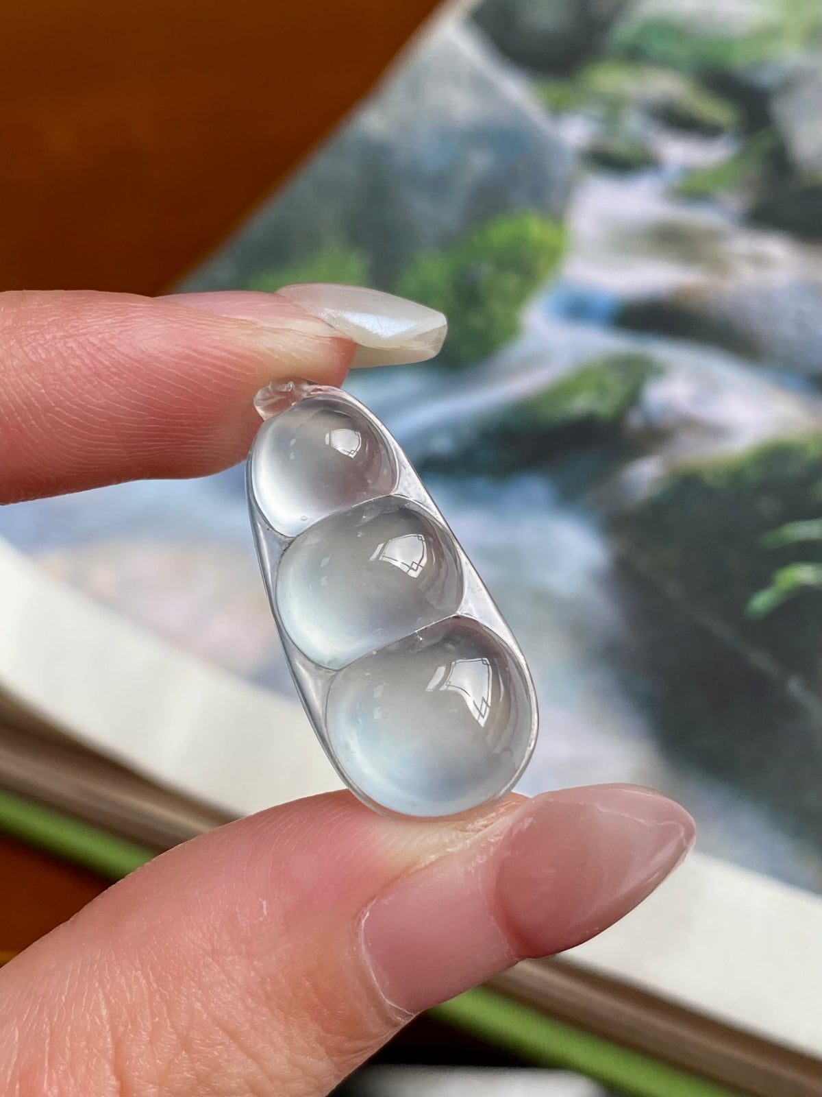 Jadeite bean pendant with three milky white oval beads in silver bezel