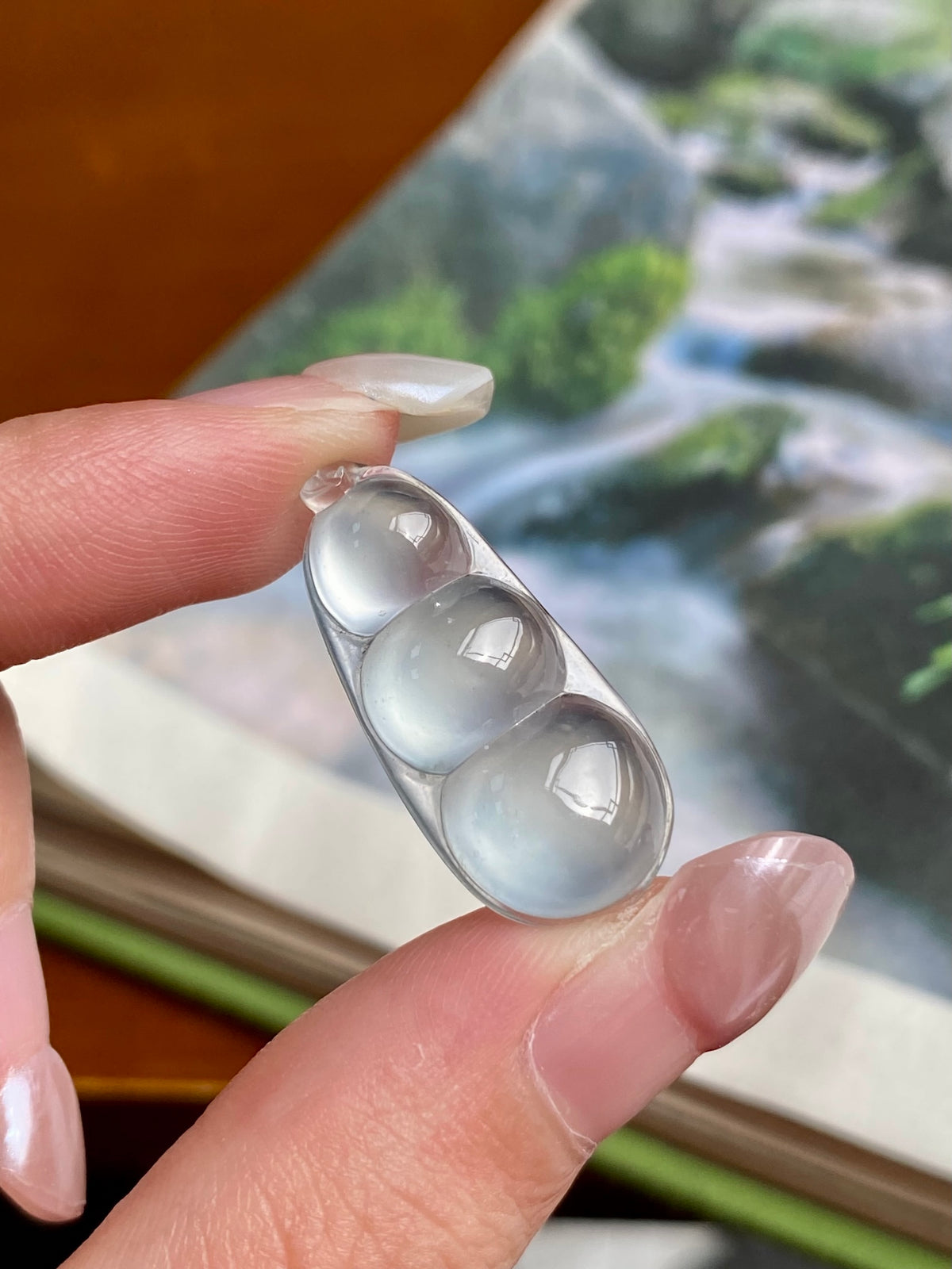 Jadeite bean pendant with three translucent icy-white bean beads in silver setting