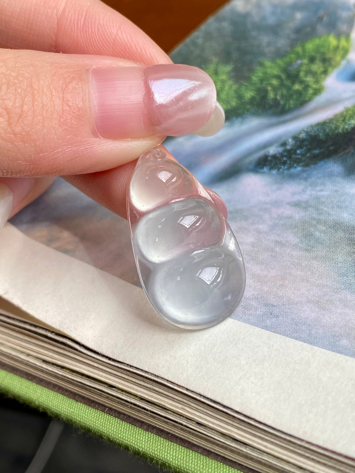 Jadeite bean pendant, translucent milky white oval with domed facets, unset