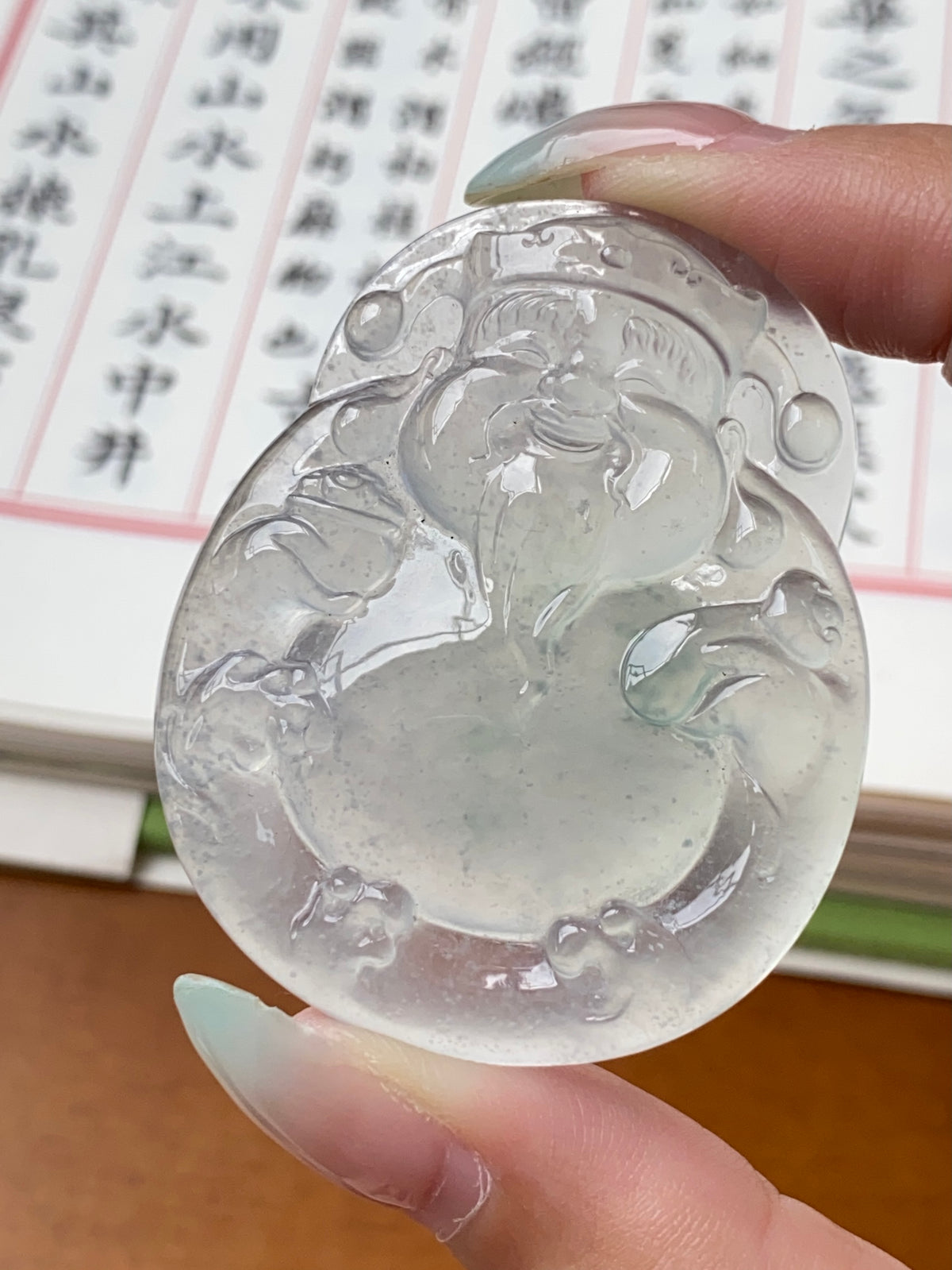 Large oval jadeite money god pendant, detailed carved relief in icy translucent white
