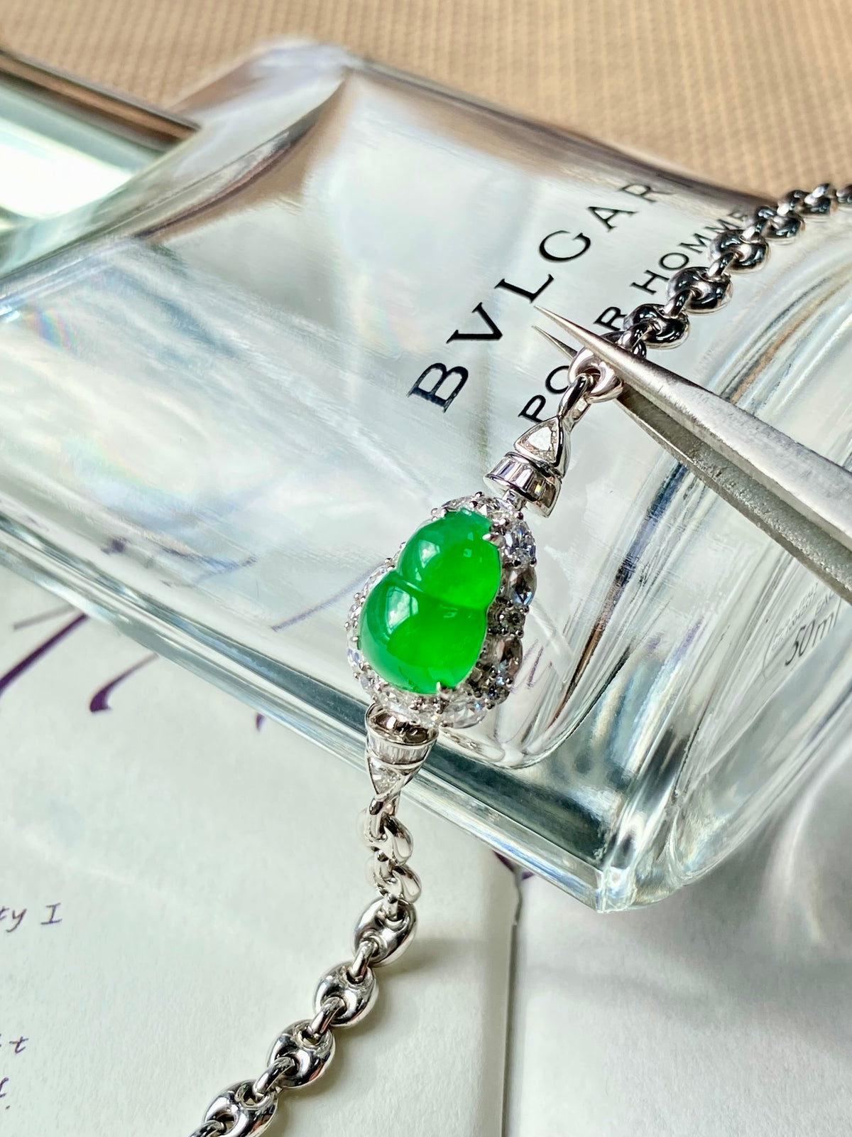 Green jadeite gourd charm bracelet with silver-toned setting and chain links