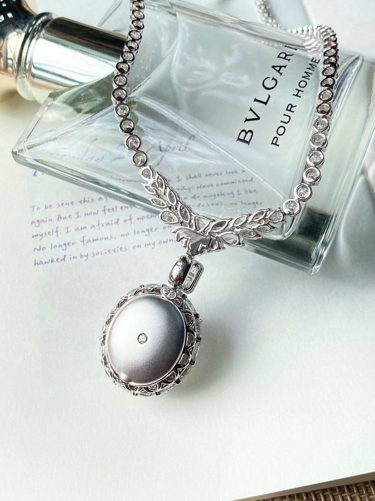 Silver-tone rhinestone necklace with oval light-blue cabochon pendant and clasp