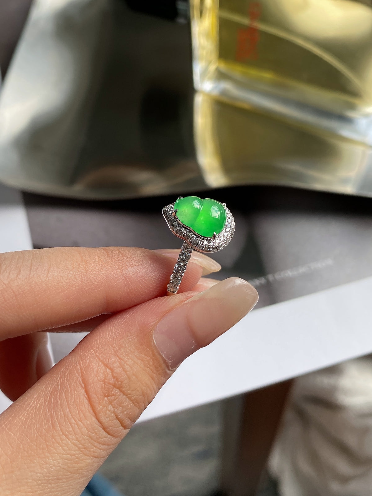 Green jadeite gourd ring top view with scalloped halo and prong-set band