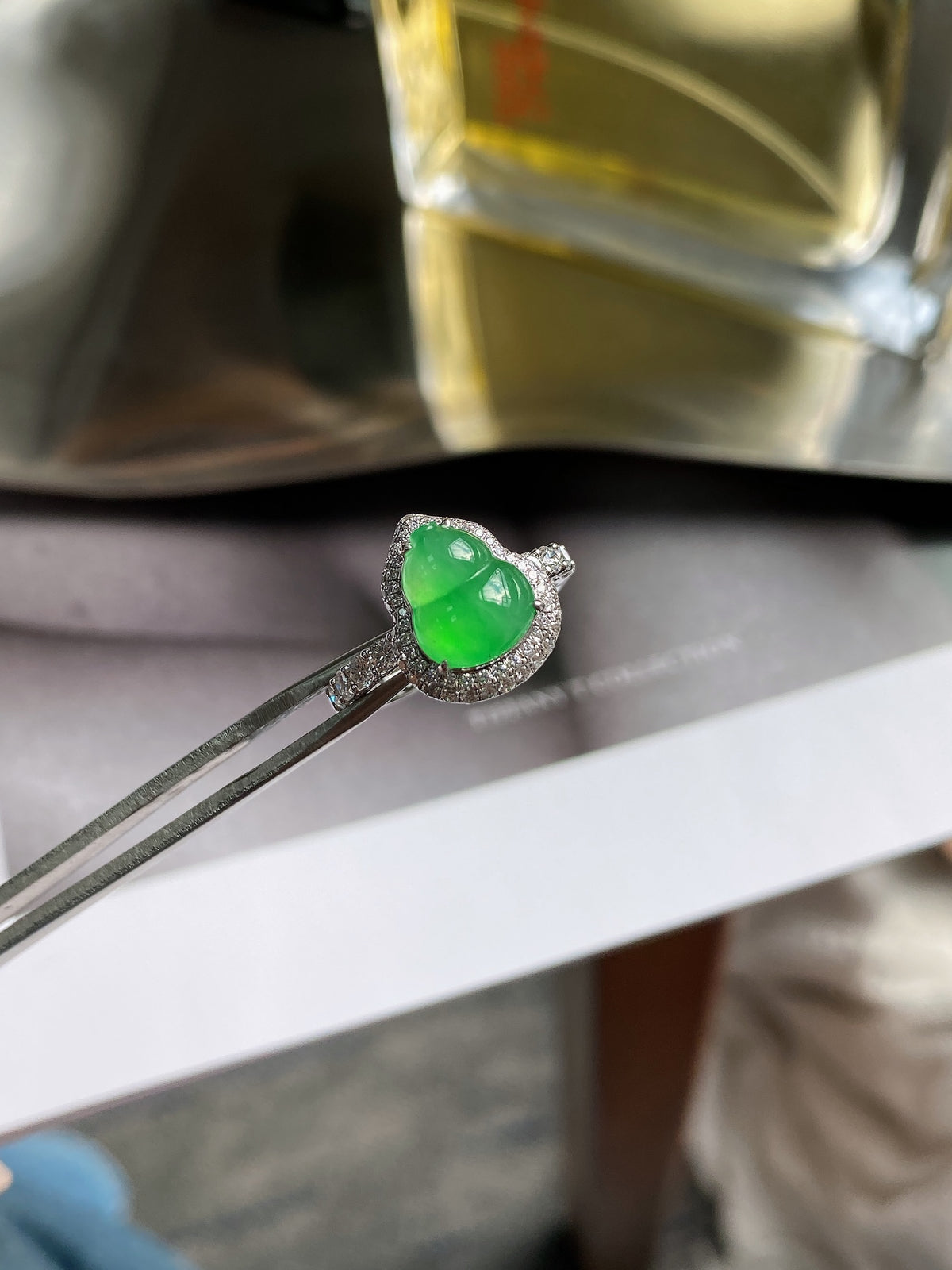 Jadeite gourd ring with bright green stone and silver setting