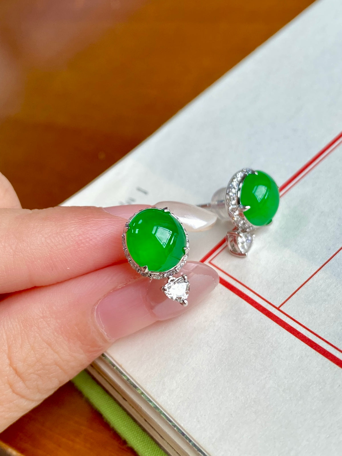 Green jade cabochon stud earrings with halo bezel and tiny crystal drop charms