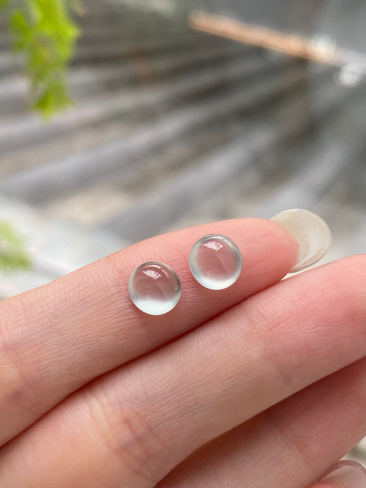 Pair of round translucent jadeite cabochons, icy white with pinkish centers