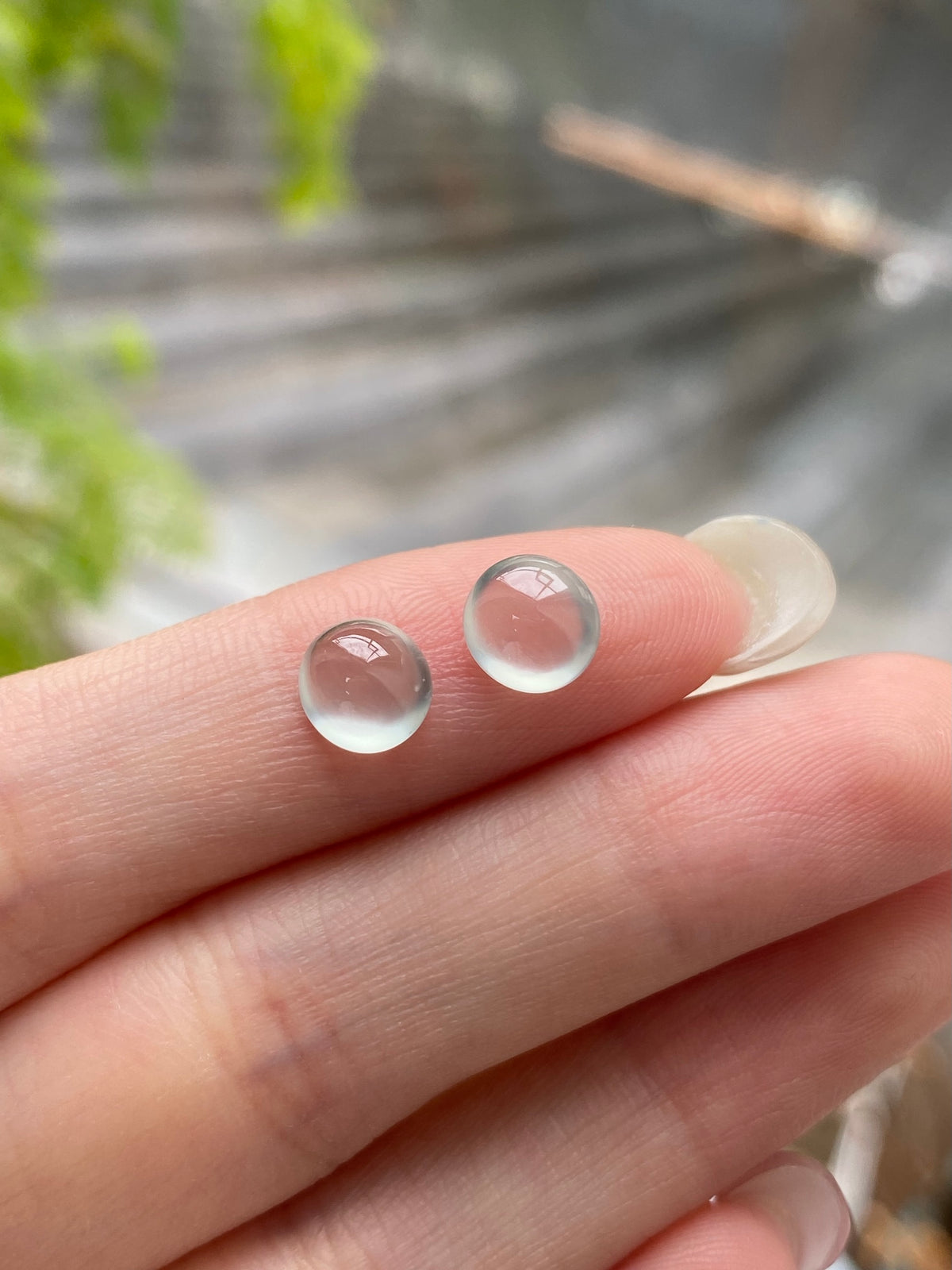 Pair of round jadeite cabochons with translucent icy white tone and soft pink