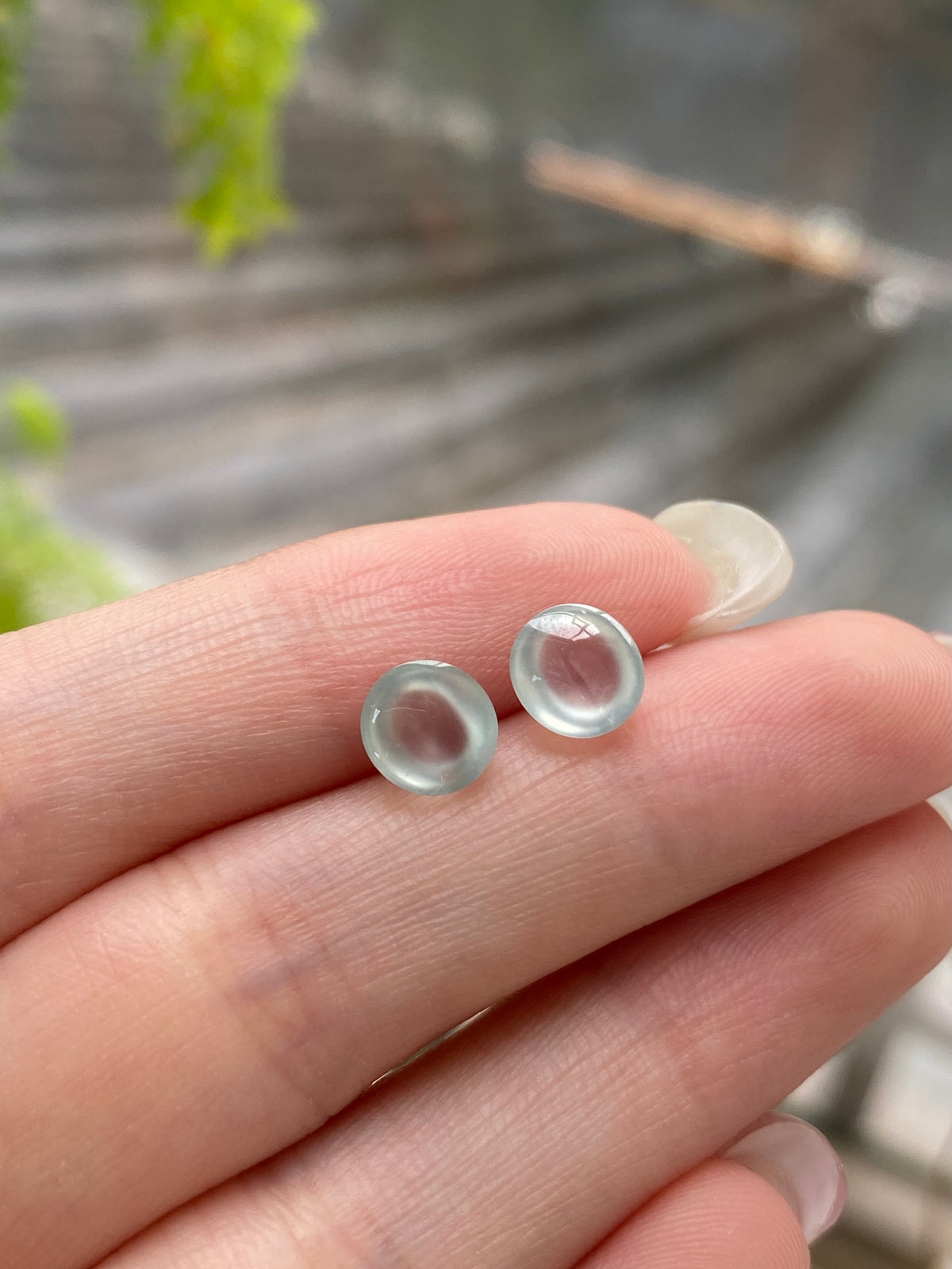 Pair of round translucent jadeite cabochons, icy white with light pink interior