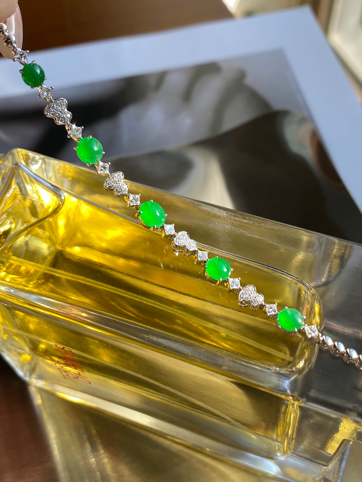 Green jadeite cabochon bracelet with silver floral links