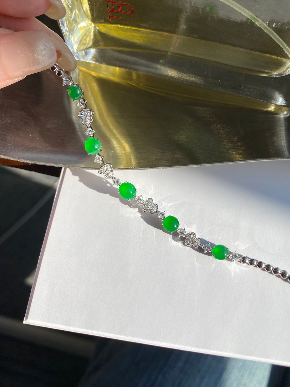 Green jade cabochon bracelet close-up, silver settings and oval green stones