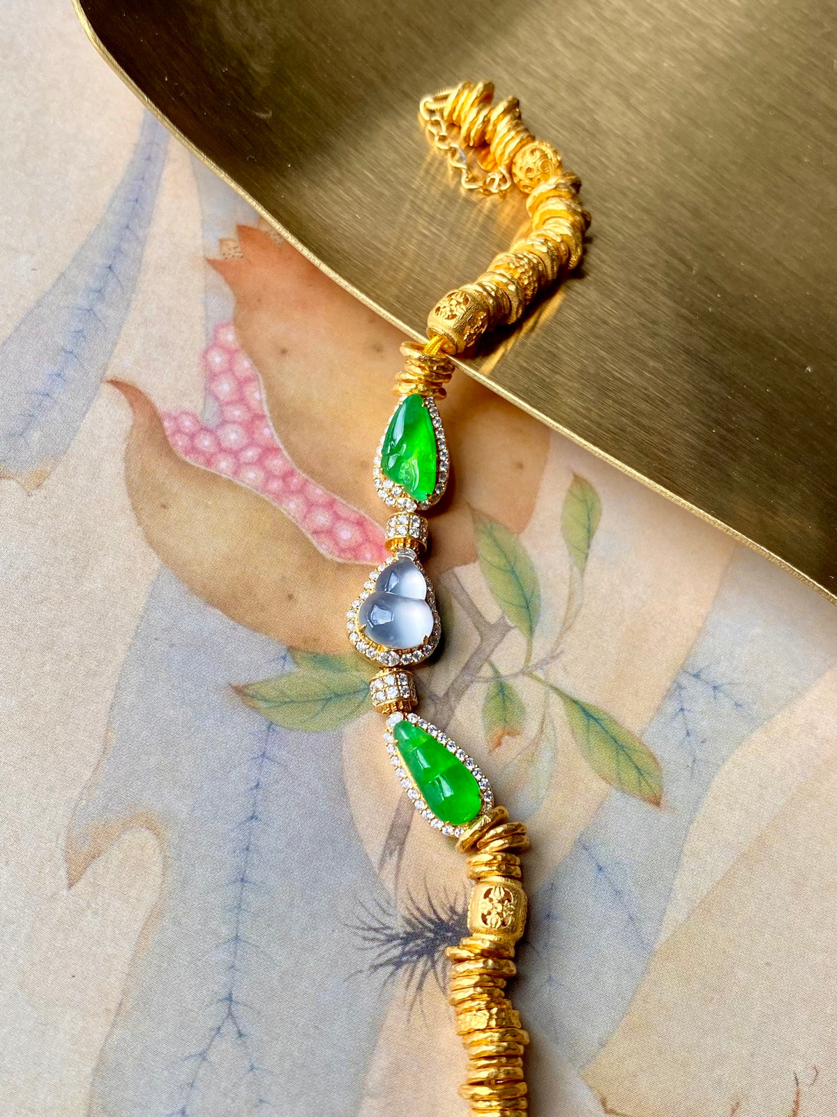 Gold jadeite gourd bracelet with alternating green teardrops and blue round beads