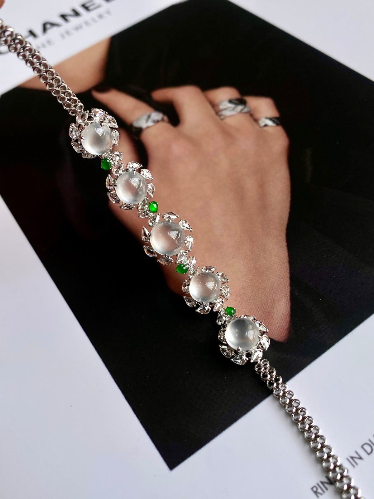 Jadeite cabochon tennis bracelet with oval white stones and small green accents