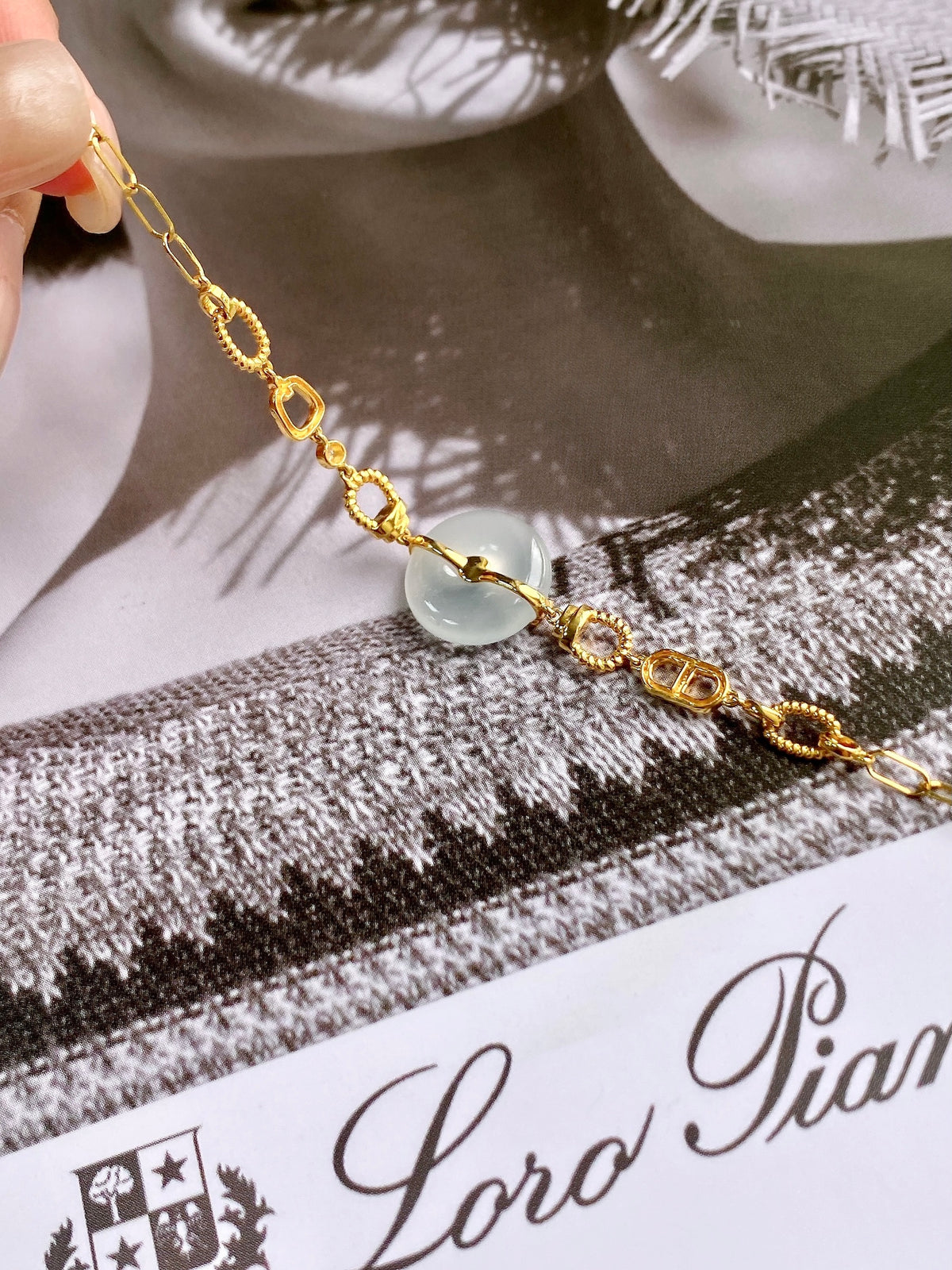 Close-up gold safety-disc bracelet with white disc bead and green center