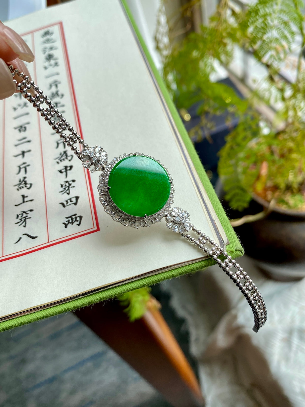 Green jadeite tablet bracelet with silver-tone chain and round green stone center