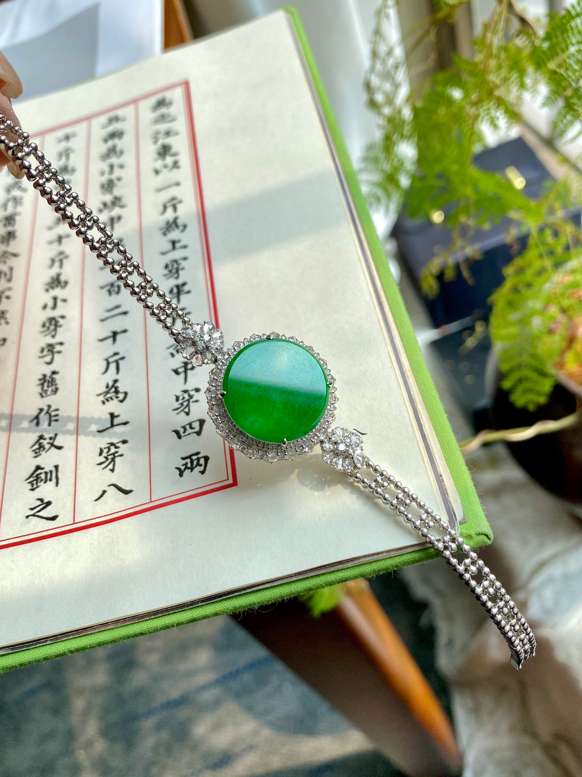 Silver bracelet with round green jadeite tablet centerpiece