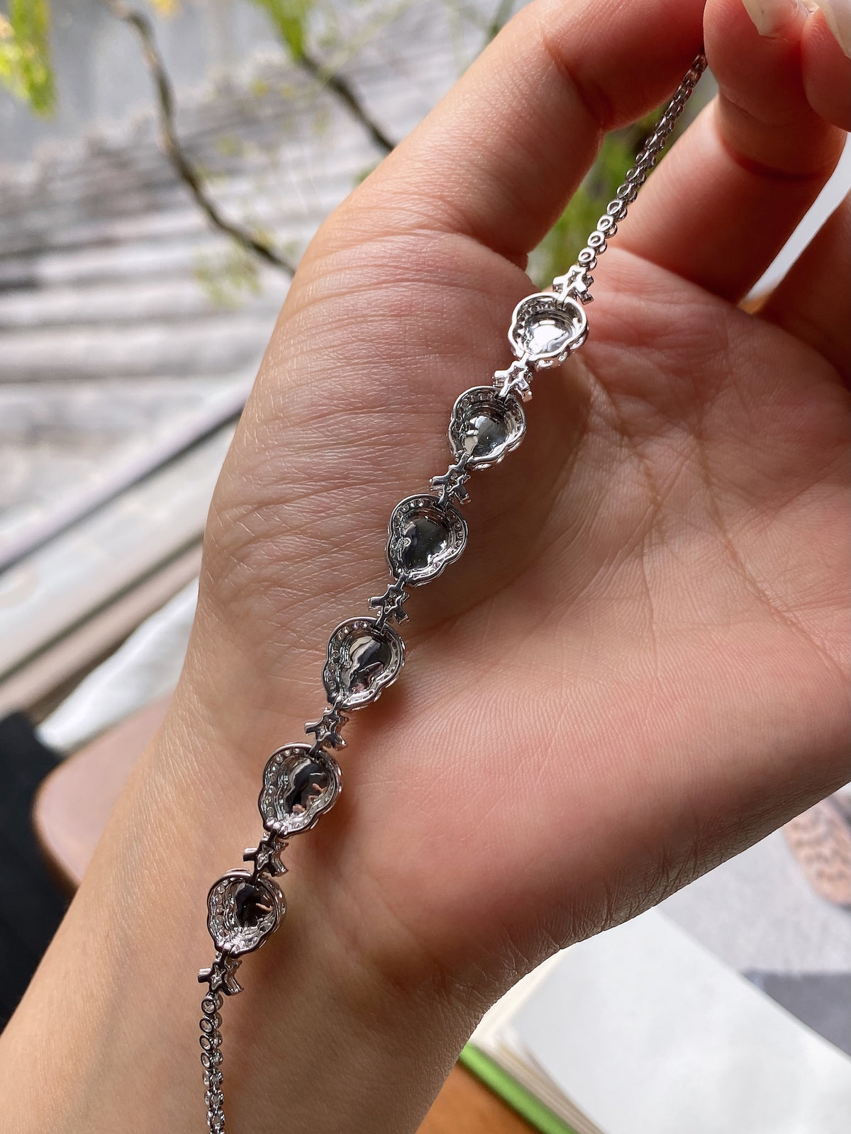 Silver-toned gourd jadeite bracelet with raised green oval cabochons on chain