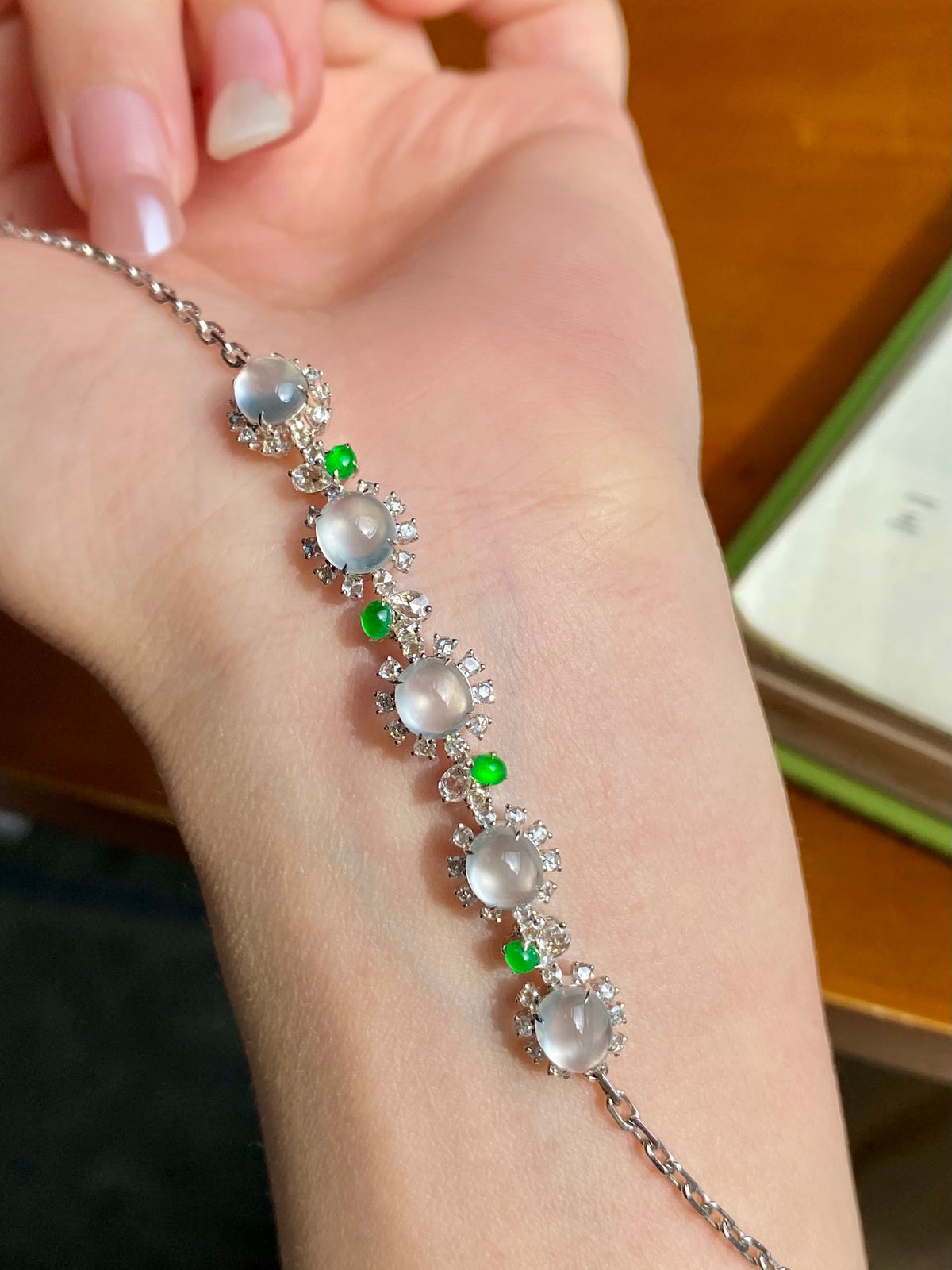 Jadeite cabochon bracelet with oval white stones, green beads, and clear sparkle accents