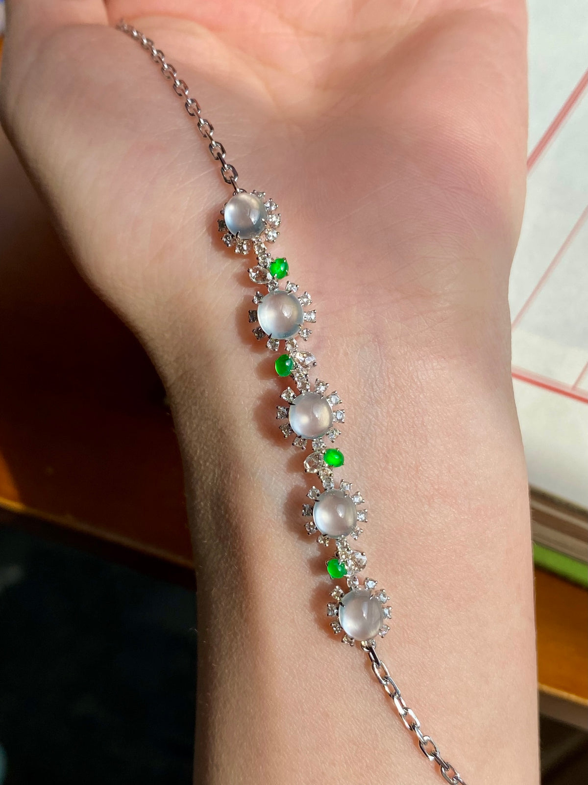 Jadeite cabochon bracelet with oval white cabochons, green beads, and silver chain links