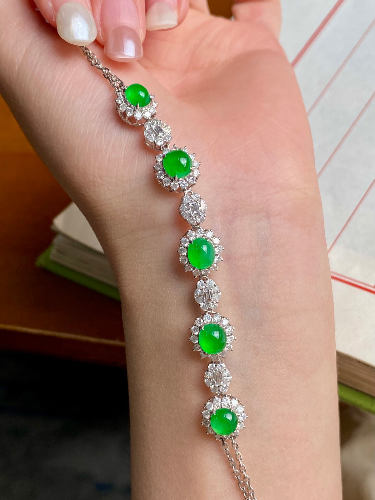 Silver-tone tennis bracelet with green oval cabochon stones and crystal cluster settings
