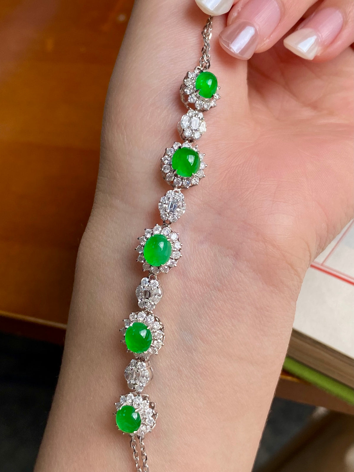 Silver-tone bracelet with multiple green oval cabochon stones in round crystal bezels