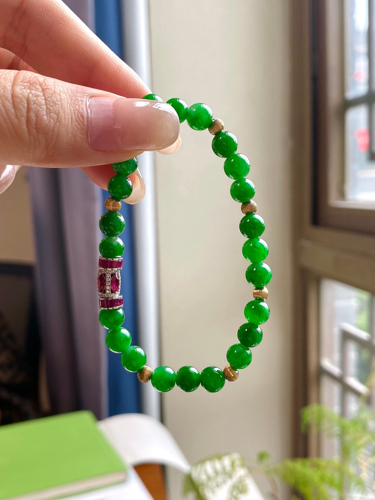 Green beaded jadeite bracelet with red centerpiece and gold spacers