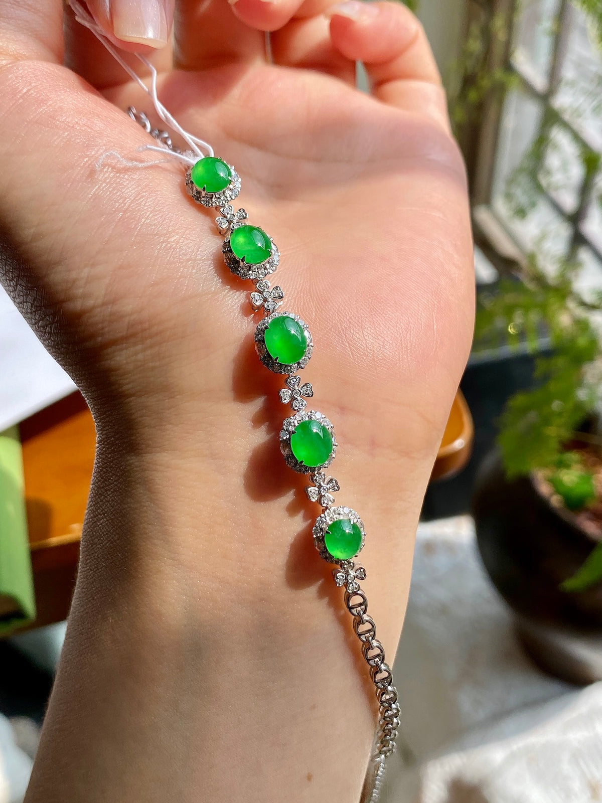 Silver bracelet with green oval jadeite cabochons and clear crystal links