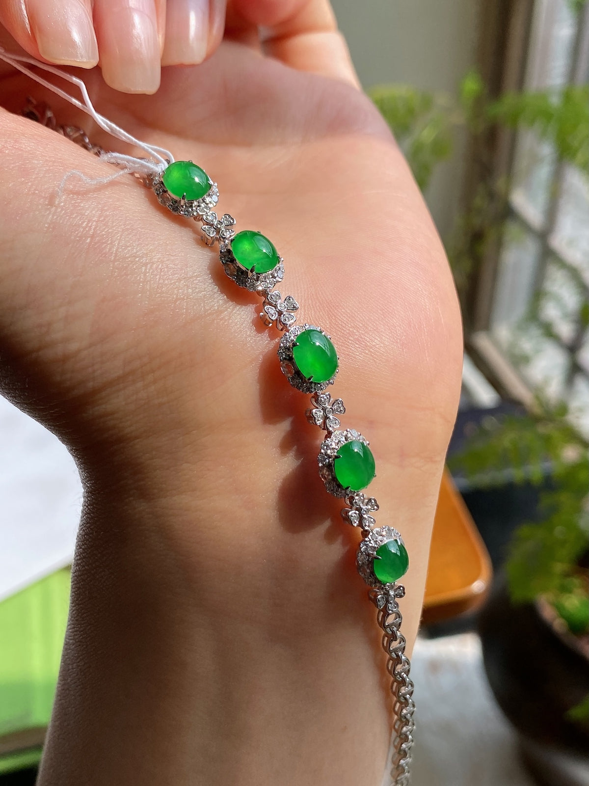 Green jadeite cabochon bracelet with five oval stones and silver flower links