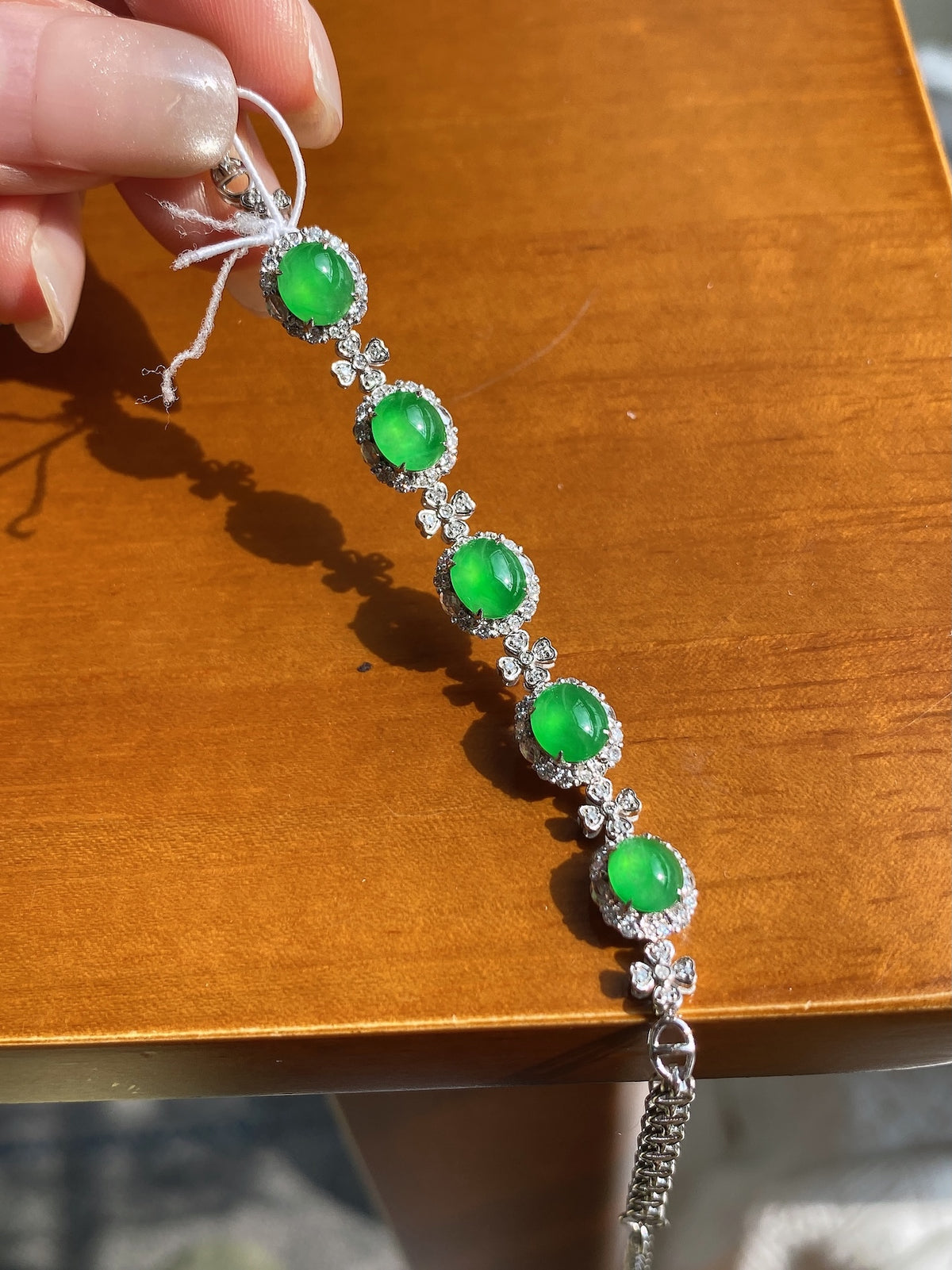 Silver jadeite cabochon bracelet with five green oval stones and crystal borders