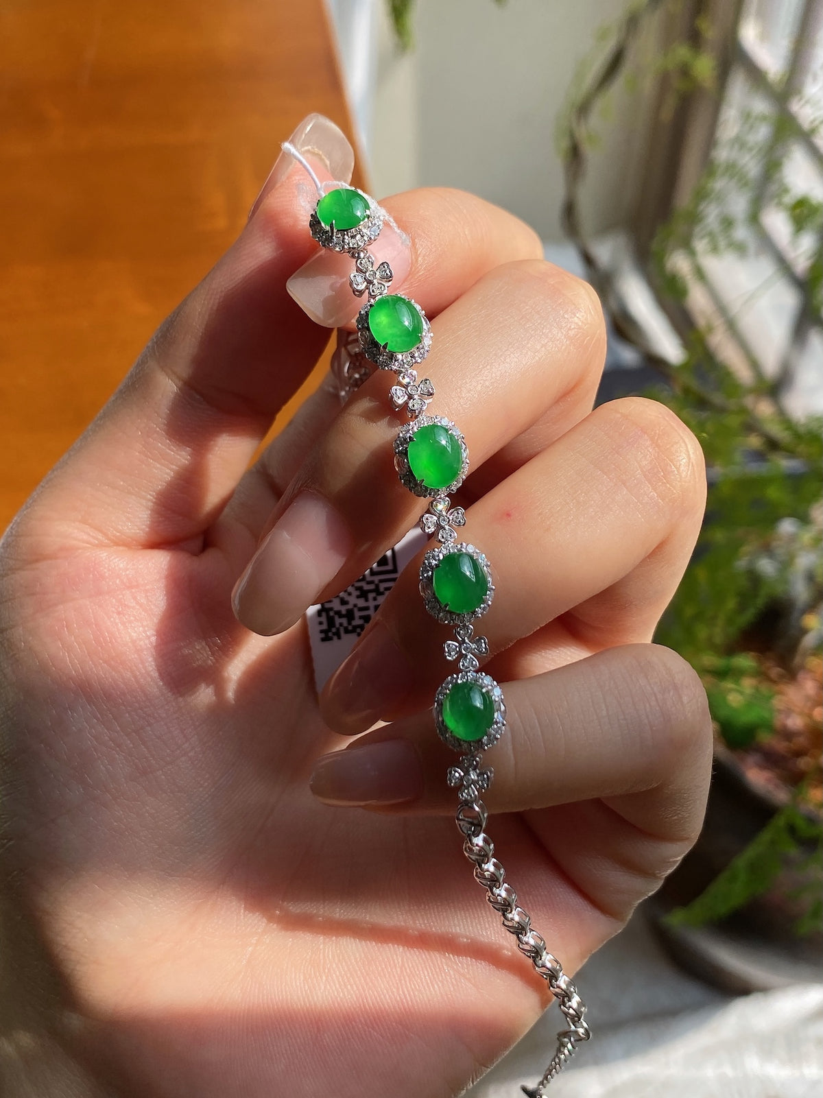 Silver bracelet with green oval jadeite cabochons, clear crystal rows, adjustable chain