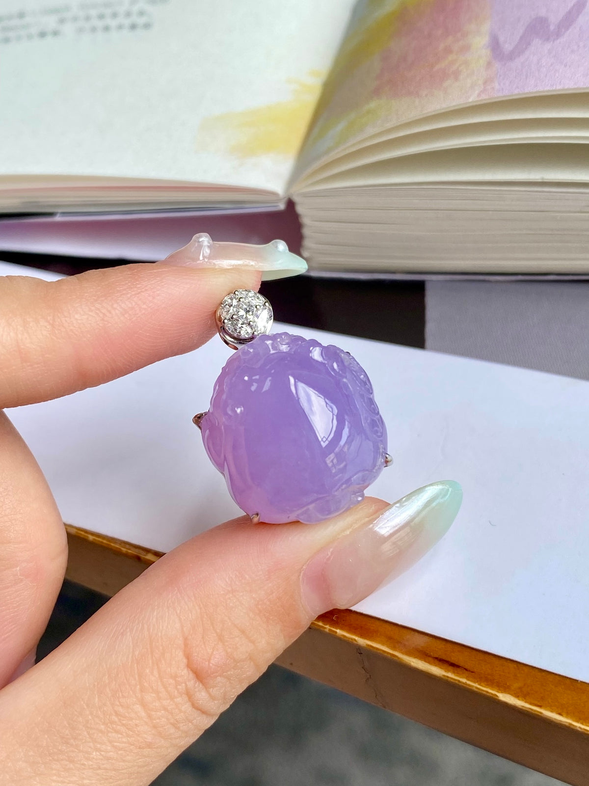 Lavender jade Pixiu pendant hanging from gold-tone ring with round crystal top