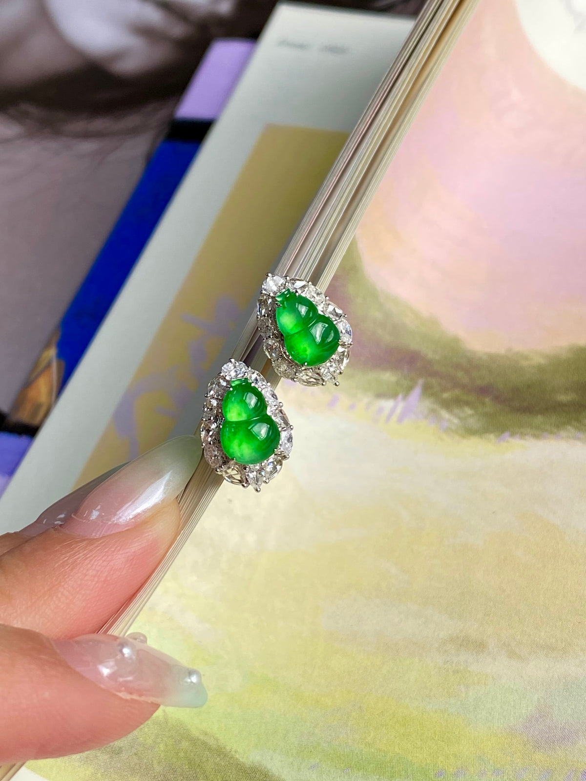 Green jadeite gourd stud earrings with crystal halo, tilted close view